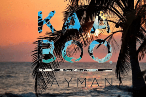 KAA BOO Cayman logo with a backdrop of a Caribbean sunset.