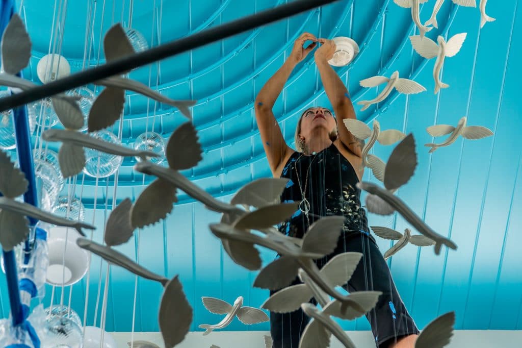 Artist Tansy Maki working on her hanging sculpture entitled 'The Flying Fish'.