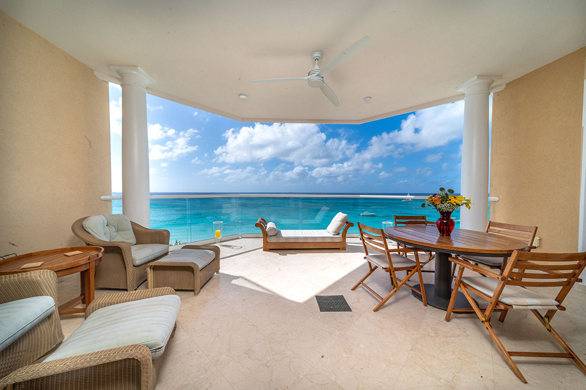 A Waters Edge Balcony with vies of the Caribbean Sea on Seven Mile Beach, Grand Cayman.