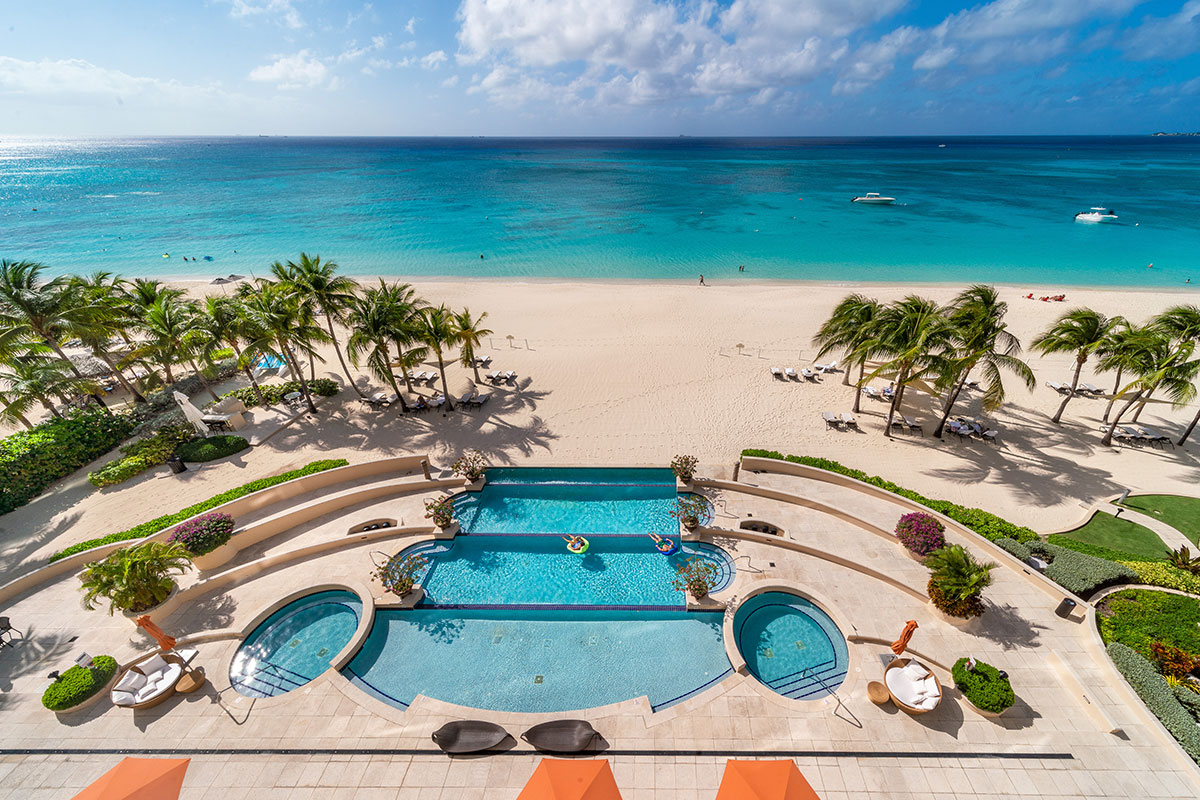 Views from Waters Edge across the pool and Seven Mile Beach to the Caribbean Sea in Grand Cayman.