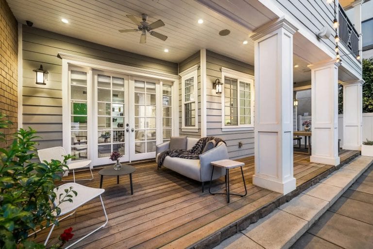 Rear covered terrace area of a colonial property.