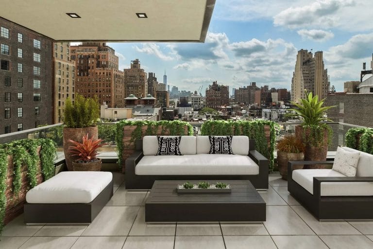 Open terrace with outdoor furniture and views of nearby skyscrapers.