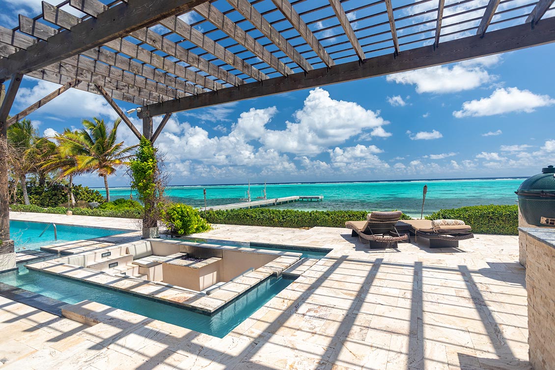 View of pool area, jetty and Caribbean Sea from Stepping Stone in Grand Cayman.