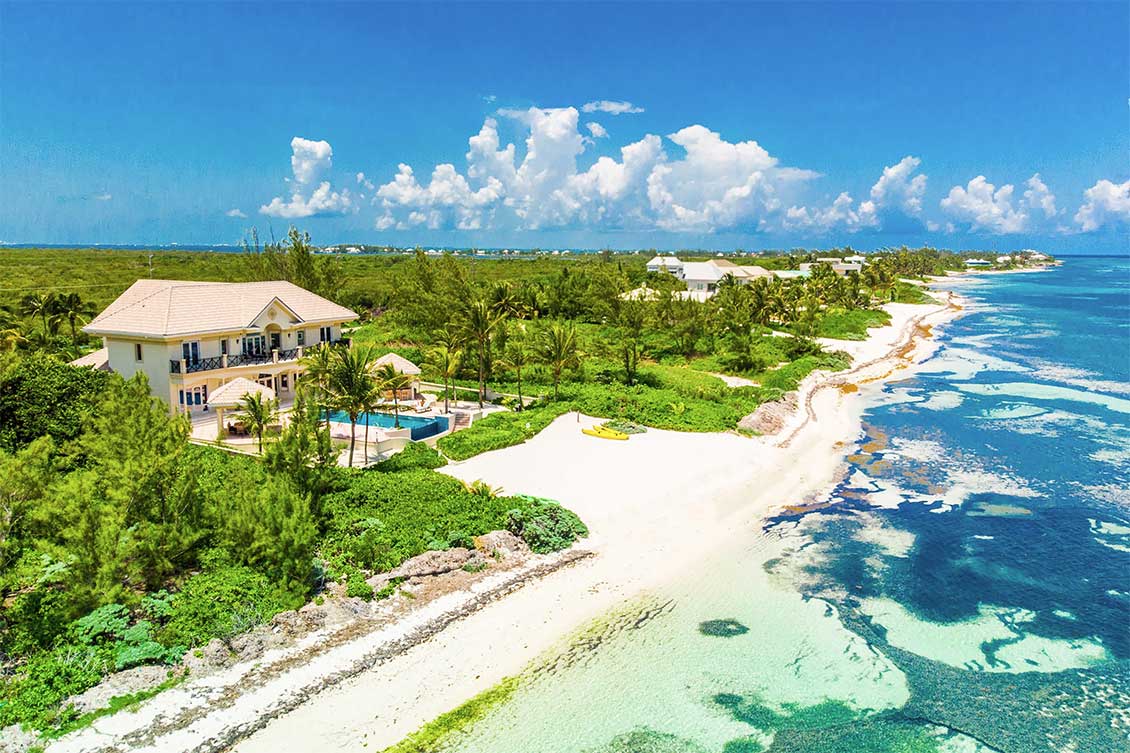 Aerial view of Blue Water Therapy showing the sandy beach and Caribbean Sea.