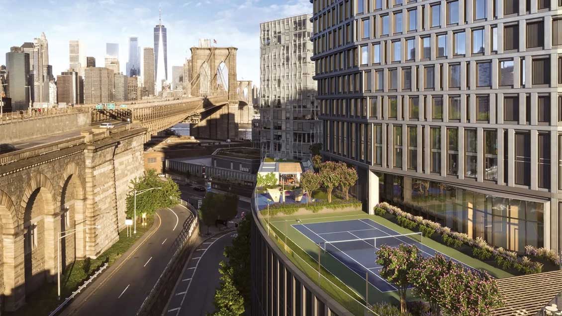 A view of the Olympia Building in Manhattan with Brooklyn Bridge and the Manhattan skyline in the background.