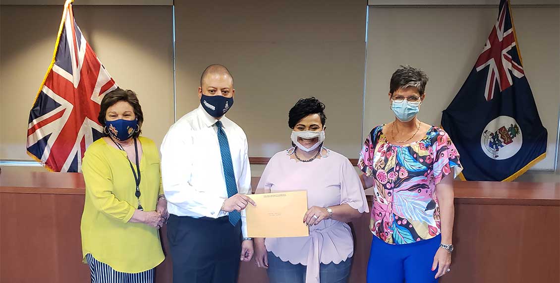 Denise receiving a donation from the Cayman Islands Government (US$396,000) from MP Heather Bodden, Hon Minister Andre Ebanks, with CICC Chair Dawn McLean-Brady.