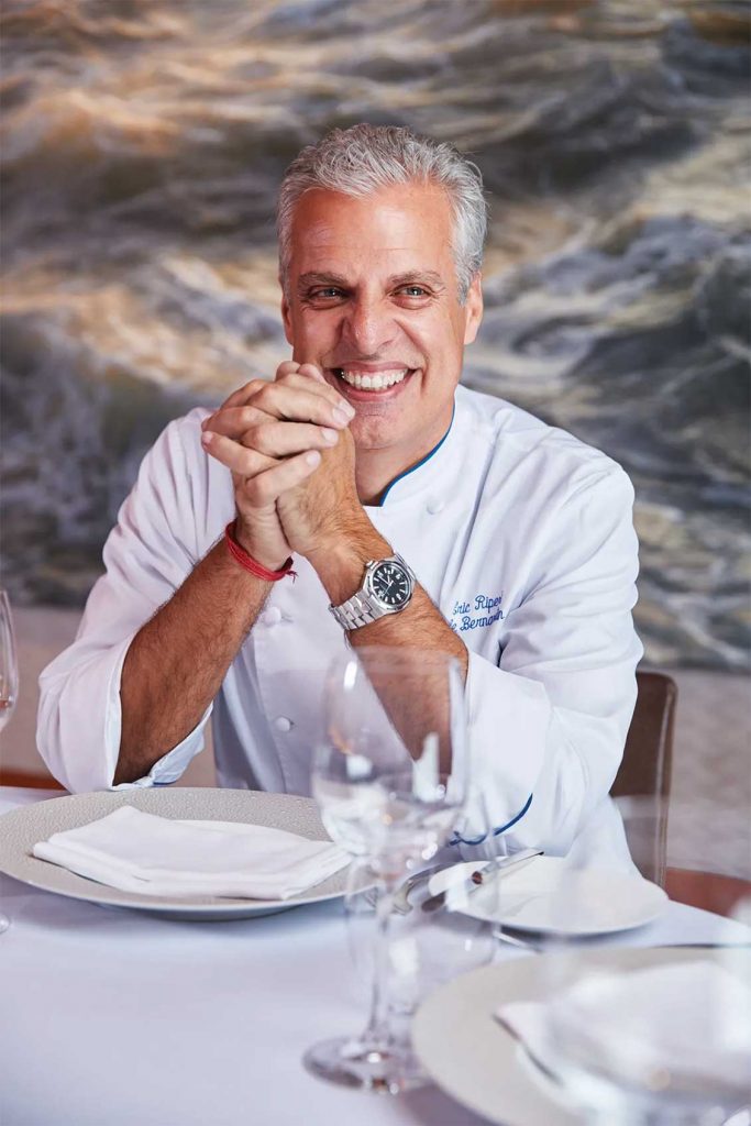 Celebrity chef Éric Ripert seated at a dining table.