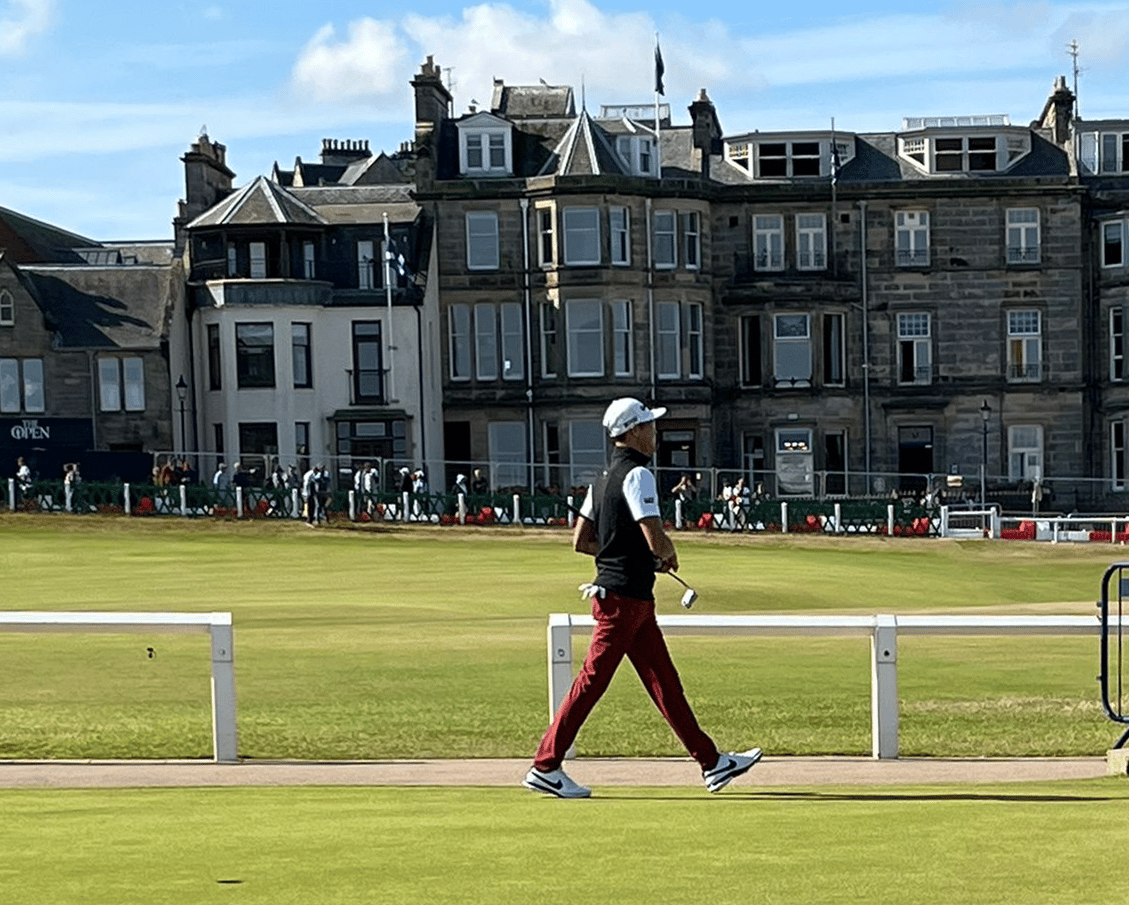 Caymanian golfer Aaron Jarvis striding onto the Old Course at Royal St. Andrews in Scotland.