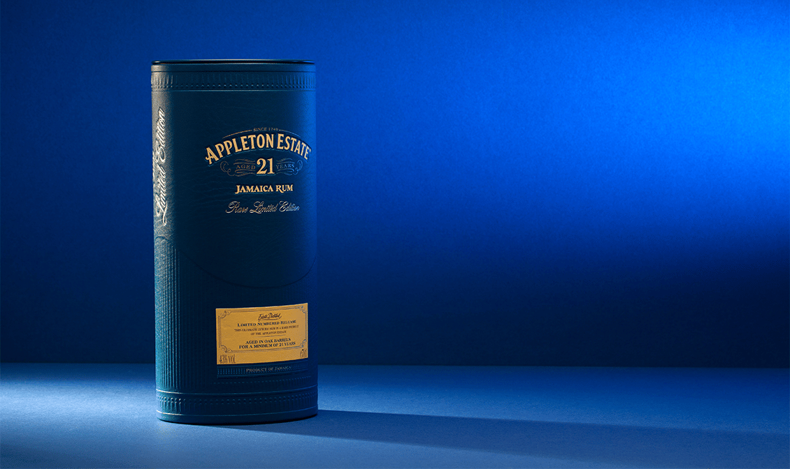 A photo of a bottle of Appleton Estate 21 year against a blue background.