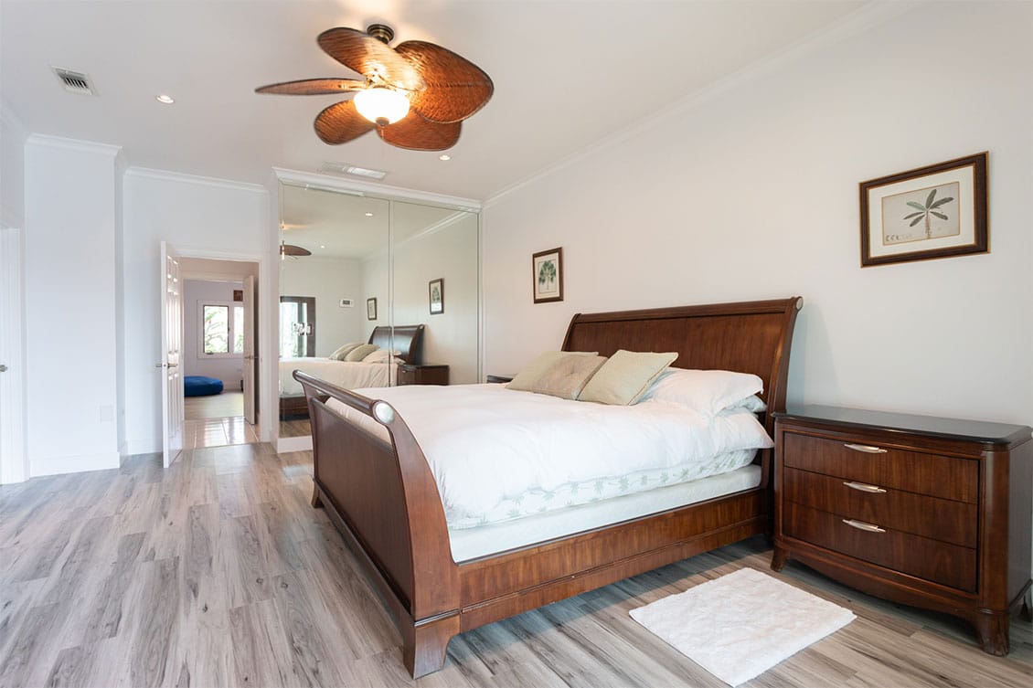 View of a bedroom with large wooden bed.