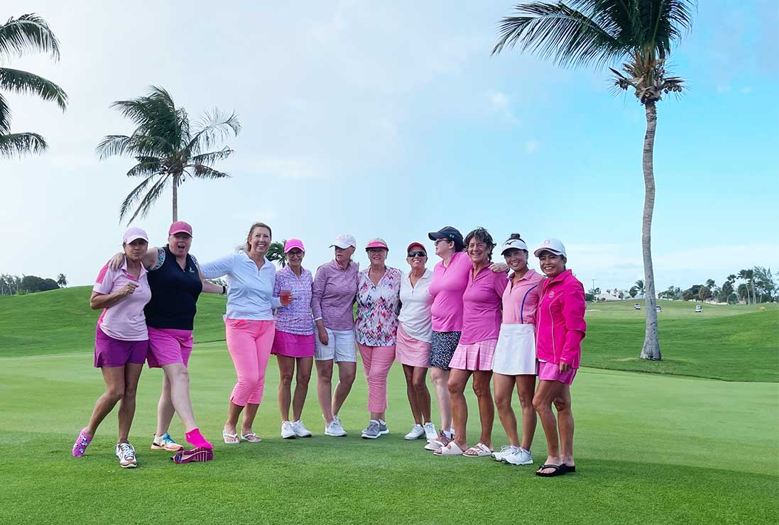 The lady participants of a Breast Cancer Awareness charity golf day all dressed in pink. North Sound Golf Club, Grand Cayman.
