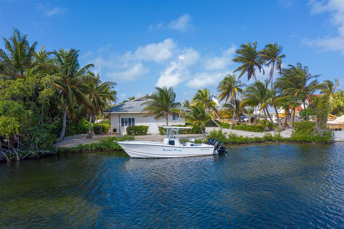 Grand Cayman anal front property with small boat moored.