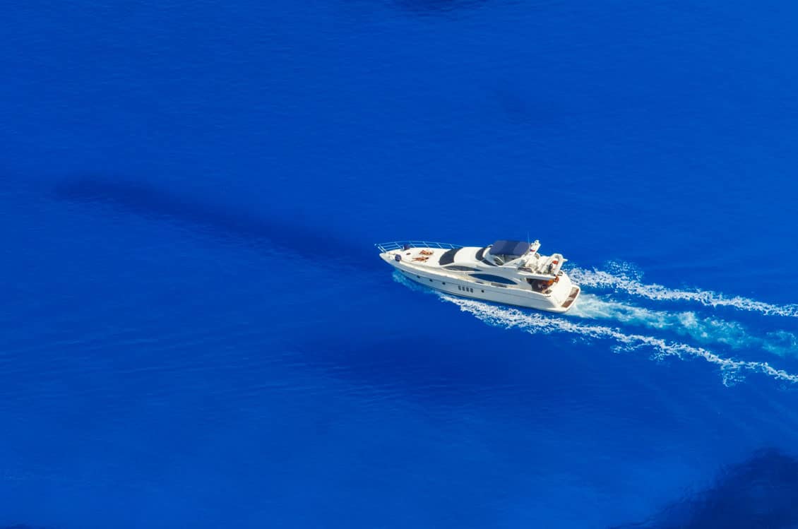 A yacht speeding through the blue of the Caribbean Sea.