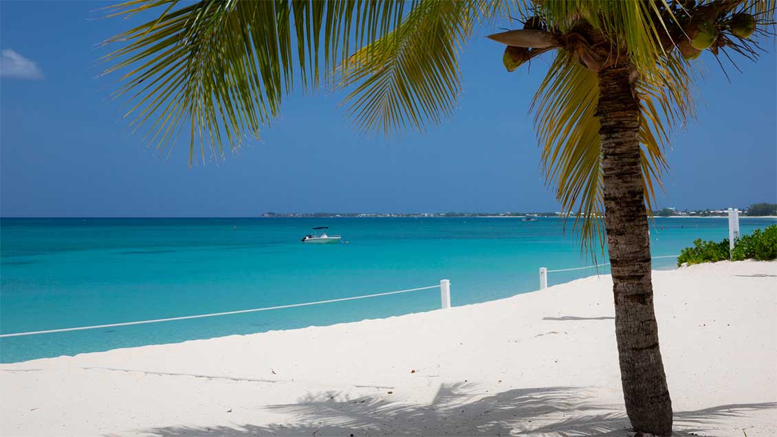 Views across the white sand for Sevewn Mile Beach towards the Caribbean Sea