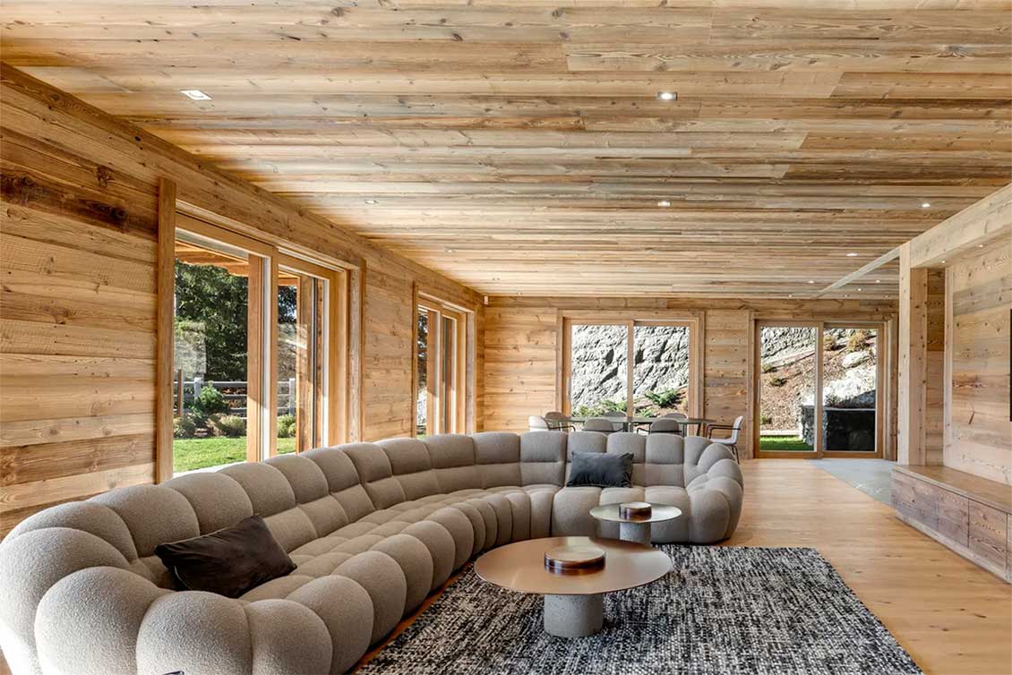 Oversized comfy sofa in a wooden chalet 