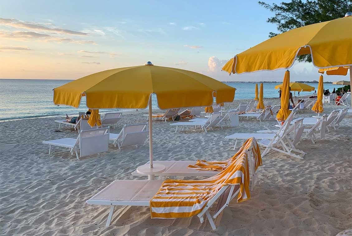 Beach loungers and umbrellas at Palm Heights Grand Cayman