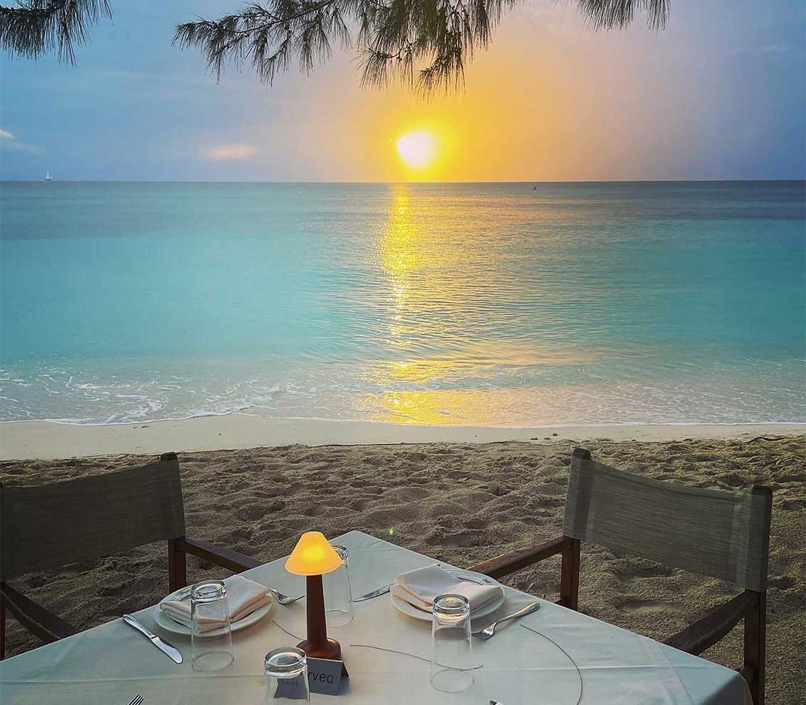 Sunset beachfront dining at Palm Heights Grand Cayman 