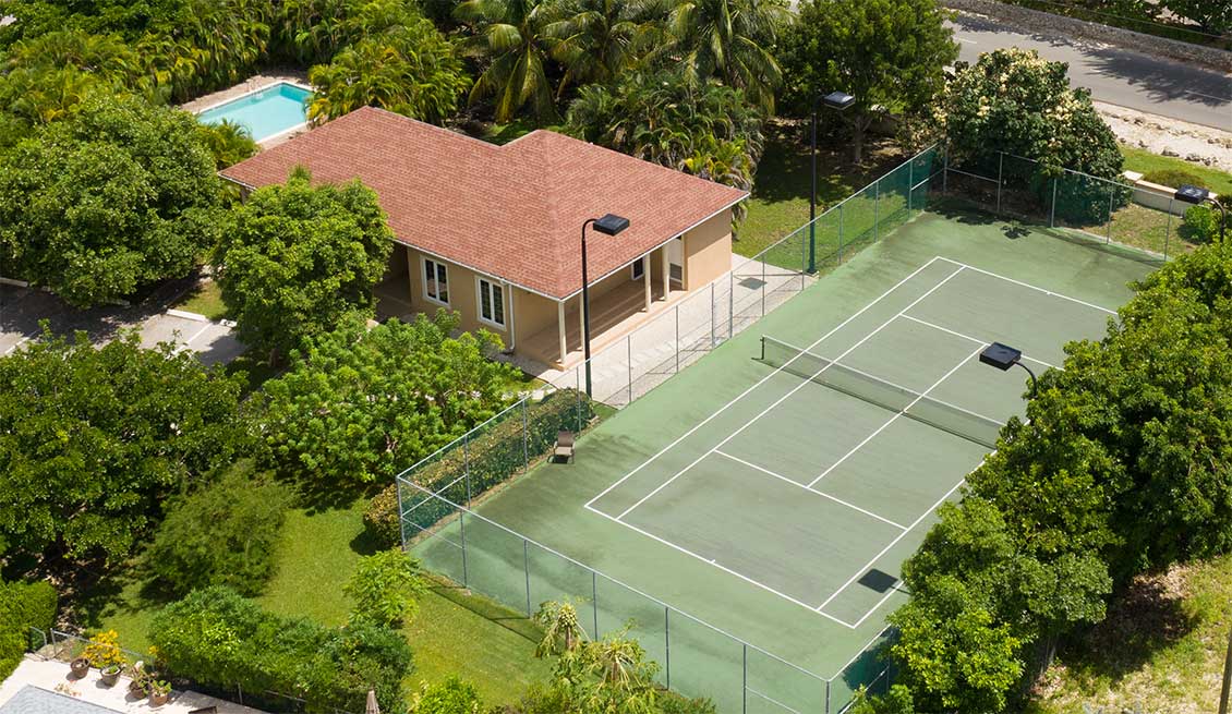The tennis courts and clubhouse at The Venetia in the Cayman Islands