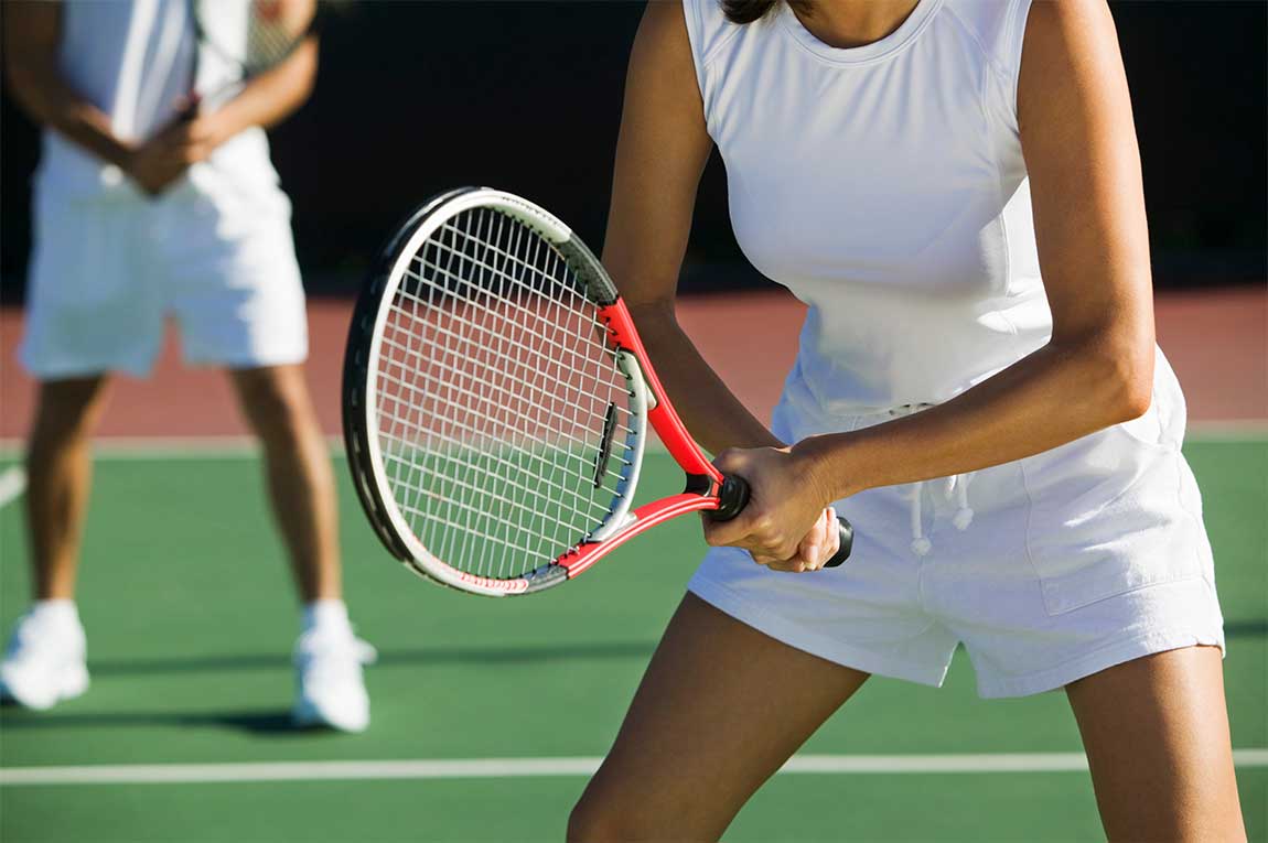 Mixed doubles tennis players on court